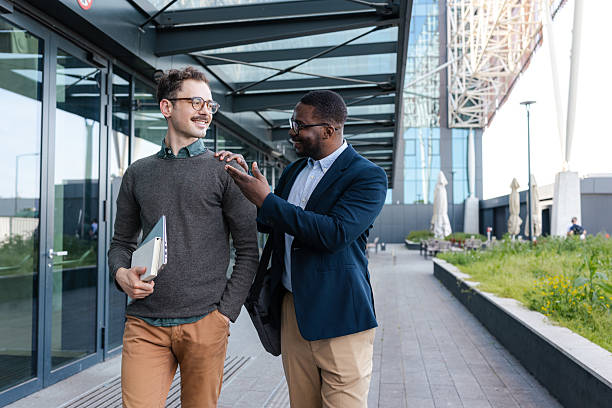 istock Colleagues are walking outdoors, engaging in friendly discussion 2214680471