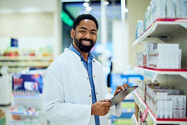 istock Smiling Pharmacist Holding a Tablet in a Pharmacy Store Aisle 2214683700