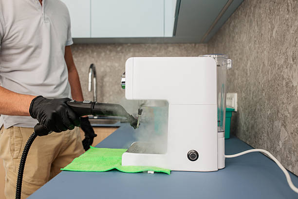 istock Office Cleaning Staff Member Washing Coffee Machine 2214685495