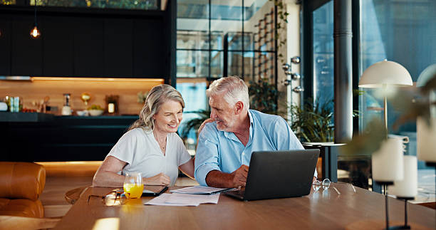 istock Documents, retirement and laptop with old couple at home for social security benefits, annuity growth and pension fund. Account balance, online banking and 401k withdrawal with people and profit 2214686880