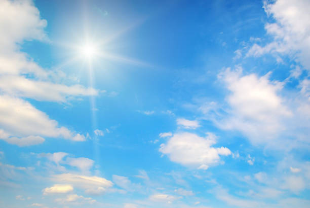 istock Bright sun and white clouds in clear blue sky 2214689190