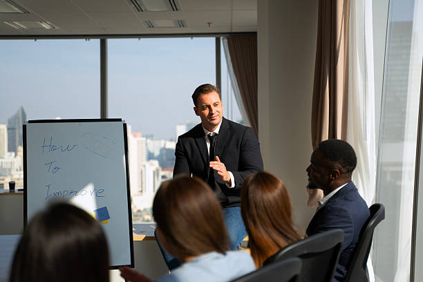 istock Group of white collar workers are training and brianstorming in office. 2214691621