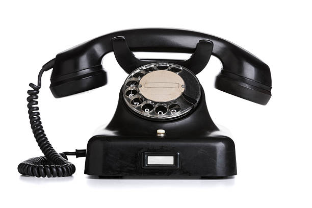 istock Vintage black rotary telephone isolated on white 2214692946