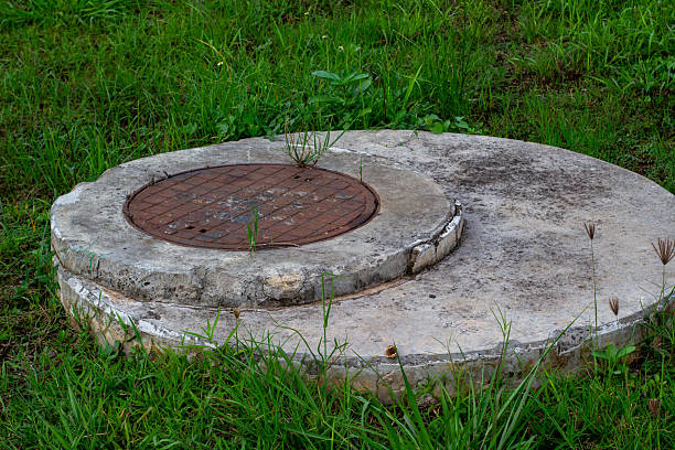istock Rusty manhole cover in concrete 2214694619