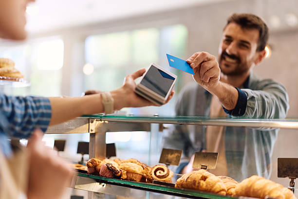 istock Close up of man paying contactless in a bakery. 2214697363