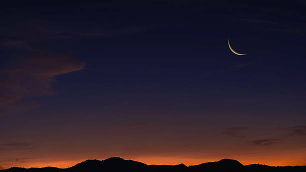 istock Sunset sky over mountain in the evening on twilight with crescent moon on dusk sky 2214698360