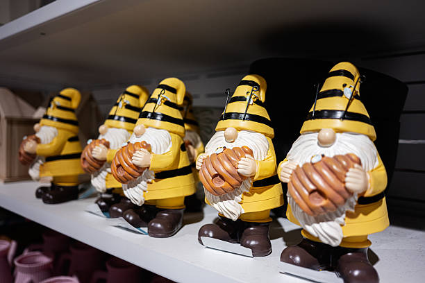 Colorful decorative gnomes dressed as bees with honeycombs displayed in a shop