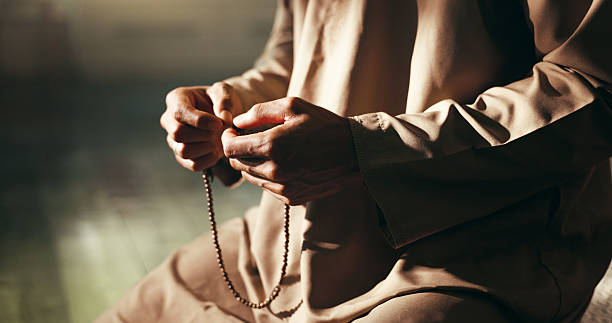 istock Hands, Islam and prayer beads in home for religion on floor for relationship with Allah in morning. Muslim person, worship and faith with trust in God for fasting, dua or reflection at apartment 2214700376