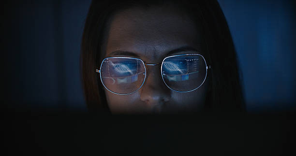 istock Female scientist working on a computer. Results of a human DNA string research displayed on the computer screen reflecting in eyeglasses. Medical science research 2214701675