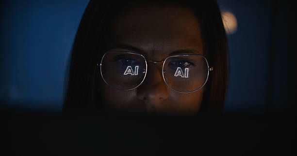 istock Female scientist working on a computer. Word 'AI' displayed on the computer screen reflecting in glasses. Computer science research 2214701679