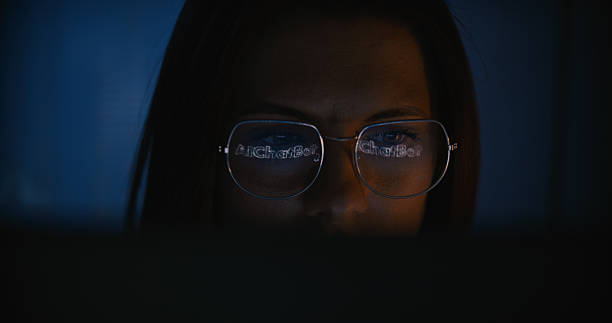 istock Female scientist working on a computer. Words 'AI chatbot' on the computer screen reflecting in glasses. Computer science research 2214701682