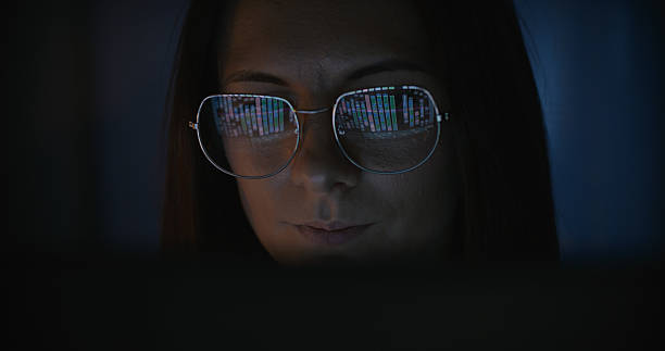 istock Female scientist working on a computer. Magnified bacteria cell displayed on the computer screen reflecting in eyeglasses. Medical science research 2214701701
