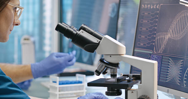 istock Medical research laboratory. Female scientist examining medical samples under a microscope. Medical science research 2214701942