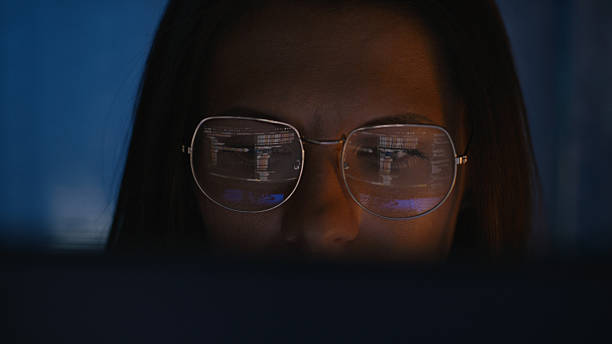 istock Female scientist working on a computer. Lines of code and calculations on the computer screen reflecting in eyeglasses. Medical science research 2214702528