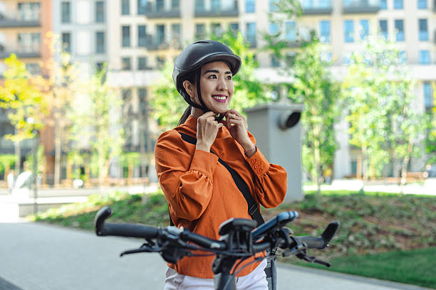 istock Woman securing bike helmet outdoors during a sunny day 2214702552