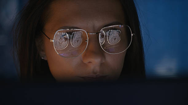 istock Female scientist working on a computer. Results of a human brain MRI scan on the computer screen reflecting in eyeglasses. Medical science research 2214702614
