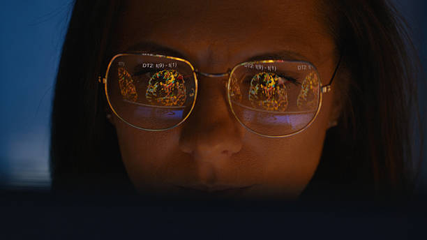istock Female scientist working on a computer. Results of a MRI scan on the computer screen reflecting in eyeglasses. Medical science research 2214702620