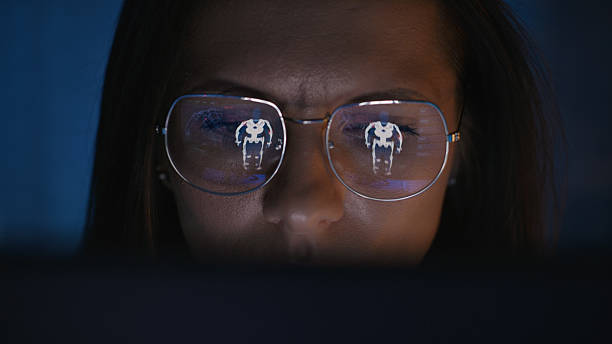 istock Female scientist working on a computer. Model of an exoskeleton on the computer screen reflecting in eyeglasses. Medical science research 2214702680