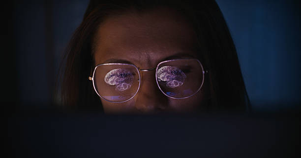 istock Female scientist working on a computer. Results of a human brain MRI scan displayed on the computer screen reflecting in eyeglasses. Medical science research 2214702848