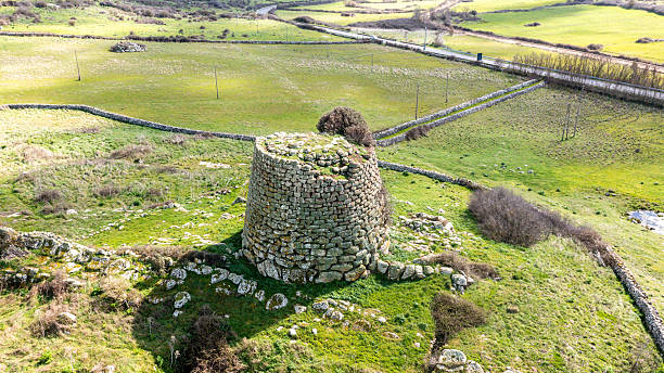 istock Ancient Nuraghe stone tower ruin in green open landscape 2214704758