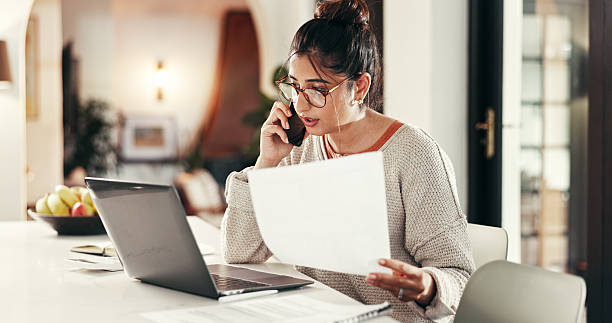 istock Phone call, contract and woman with laptop in house with remote work for client feedback. Computer, document and female event planner with freelance job on mobile discussion for vendor booking. 2214707298