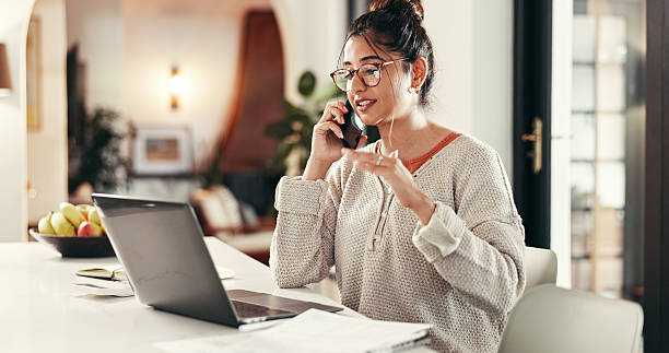 istock Phone call, remote work and woman with laptop in home with communication for client feedback. Computer, contact and female event planner with freelance job on mobile discussion for vendor negotiation 2214707308