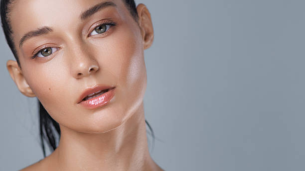 istock Front-Facing Beauty Portrait With Dewy Skin And Nude Glossy Lips 2214711384