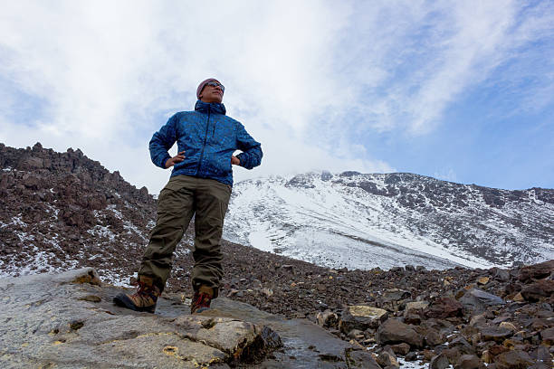 Mountaineer standing proudly on the slopes of pico de orizaba, mexico's highest peak, showcasing the beauty and challenge of mountaineering