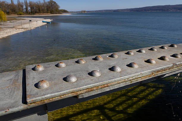 Rudolfzell Bodensee, Baden Wurttemberg Germany. Lake Constance. Shoreline and beach. Steel bridge with nails.