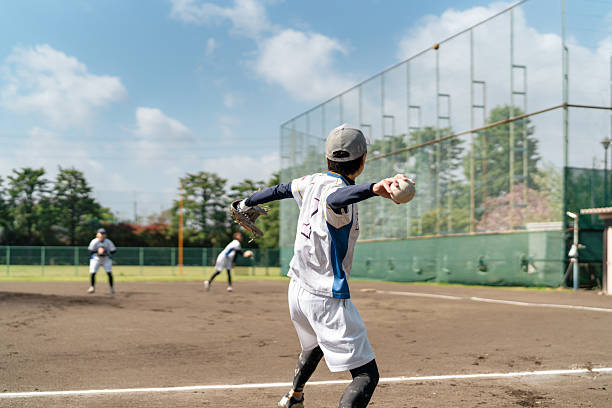 istock Female Softball Team Practicing on a Suburban Field in Tokyo 2214715161