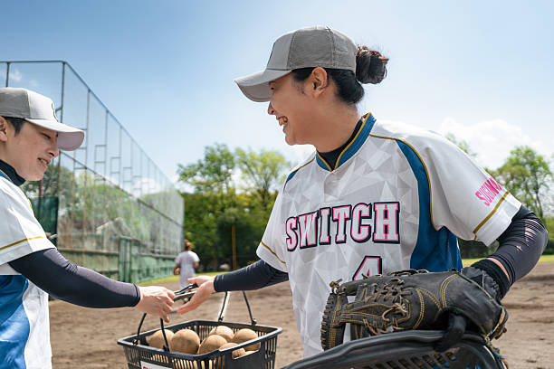 istock Female Softball Team Practicing on Sunny Tokyo Field 2214715185