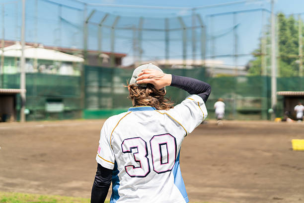 Volunteer baseball coach gives advice to little league players during game