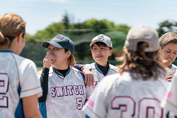 istock Female Softball Team Practicing and Bonding in a Tokyo Suburb Field 2214715227