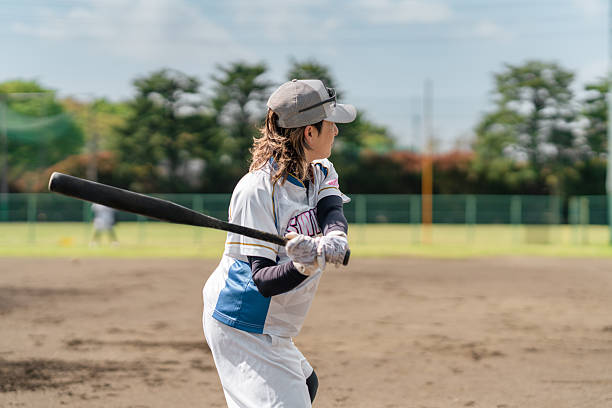istock Female Softball Player Practicing Swing on a Sunny Field 2214715229