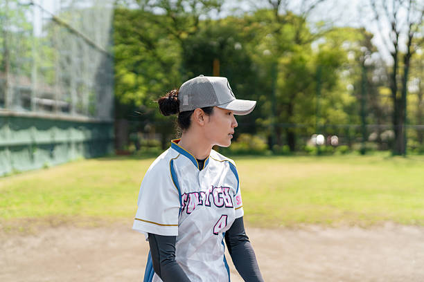 istock Female Softball Player Practicing on a Tokyo Suburb Field 2214715237