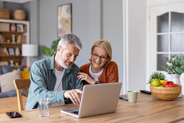 istock Couple Enjoying Time Together While Using a Laptop at Home 2214717027