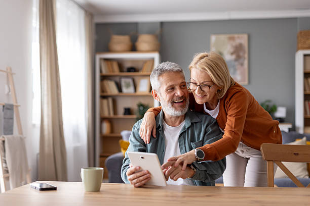 istock A joyful couple sharing a moment over a tablet screen. 2214717039