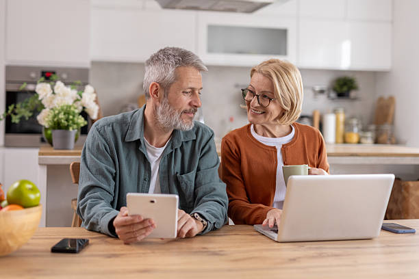 istock Couple Interacting with Devices and Each Other in Modern Kitchen 2214717054