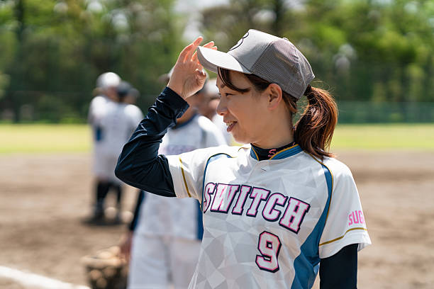 istock Female Softball Player Smiling During Field Practice 2214721534