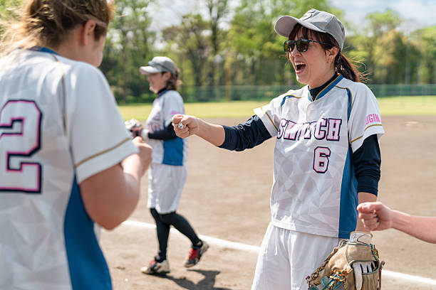 istock Female Softball Team Bonding During Practice in a Tokyo Suburb Field 2214721554