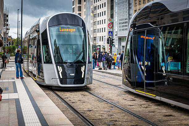 Luxembourg City, Luxembourg - September 25, 2024: People waiting for the modern tram at a tram station in Luxembourg City