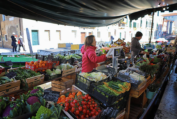 3/3 - 2025. Italy, - Venice.Around the station you have a canal where floating vegetable markets are available for the citizen of Venice. Here you see how normal life unfolds in a floating city with no cars.