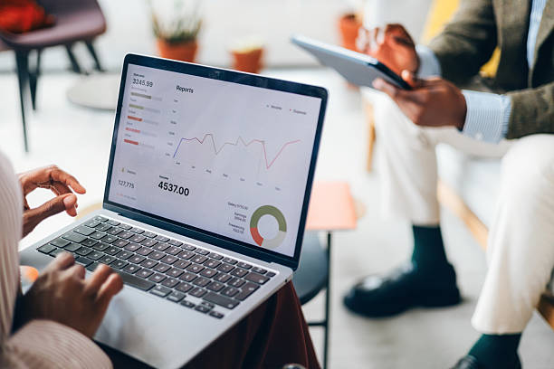 istock Business Team Analyzing Financial Data on Laptop with Digital Reports 2214727178