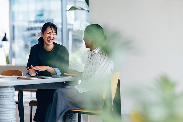 istock Two Happy Colleagues Sharing a Laugh During a Casual Team Meeting 2214727186