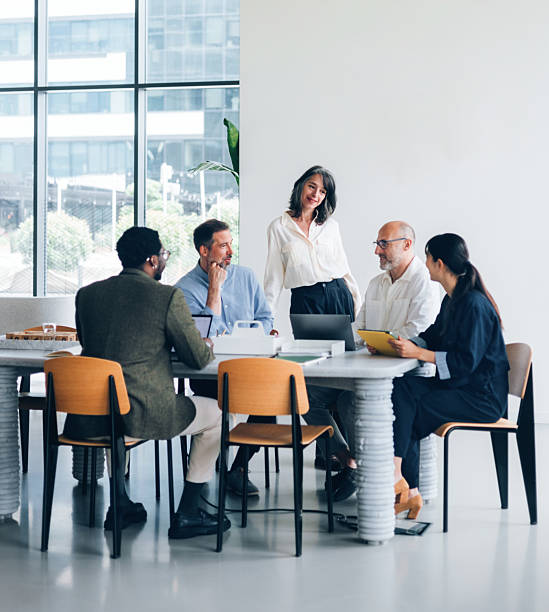 istock Professional Team Engaged in Discussion in Modern Office Meeting Room 2214727208