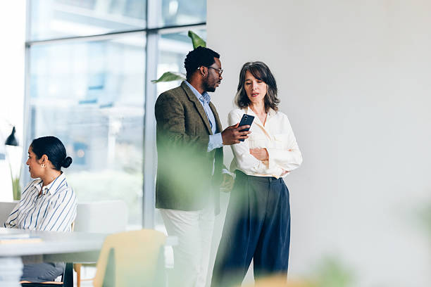 istock Business Professionals Interacting in a Modern Office Environment 2214727243