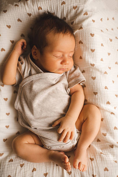 istock Cute baby boy sleeping in bed 2214727674