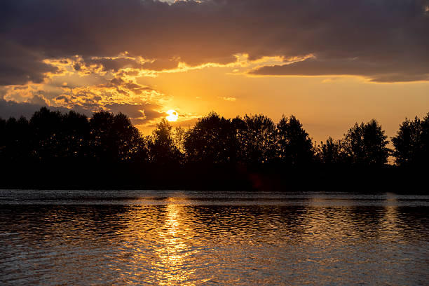 istock river at sunset, the colorful sky and clouds are reflected on the river 2214728170