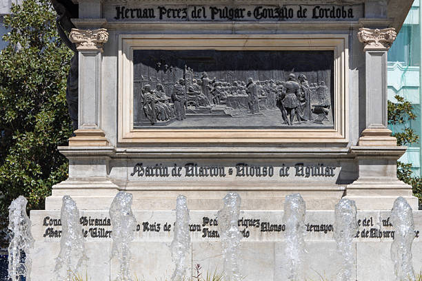 Granada; Spain; Andalusia - March 28; 2025: Relief on base of monument to Isabella the Catholic; bronze sculpture depicting meeting Queen Isabella with Christopher Columbus
