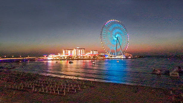 istock Illuminated Ferris wheel in Jumeira district   -  drone view in night 2214729247